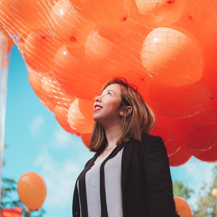 Asha Kapoor, Lead Design Curator at Paper Harbor Gate, reviewing corporate floral arrangements